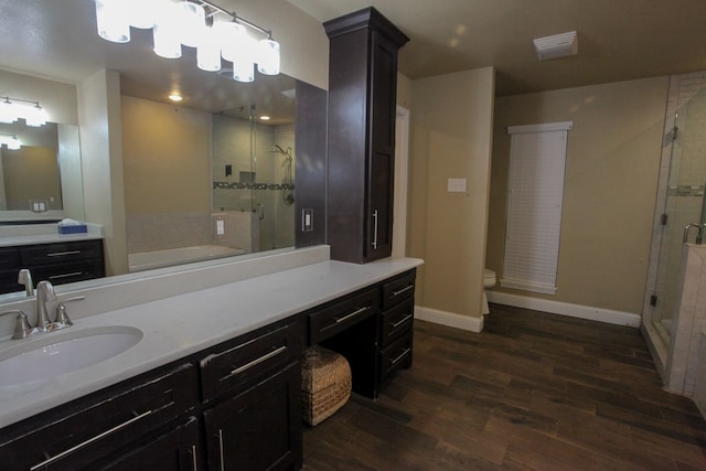 full bathroom featuring hardwood / wood-style floors, vanity, toilet, and plus walk in shower