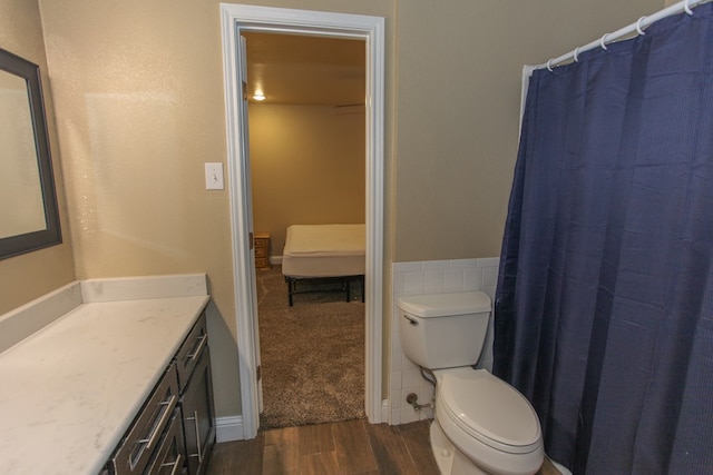 bathroom with vanity, toilet, and wood-type flooring