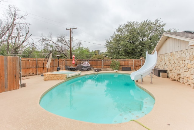 view of pool with a patio area and a water slide