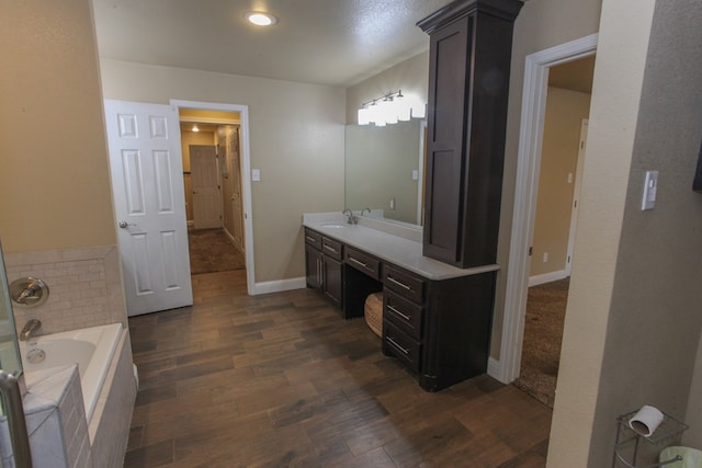 bathroom featuring a bathtub, vanity, and wood-type flooring