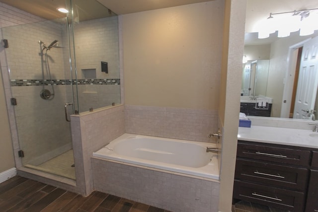 bathroom with vanity, wood-type flooring, and independent shower and bath