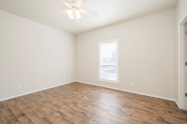 unfurnished room featuring dark wood-type flooring and ceiling fan