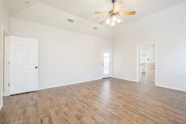 spare room featuring vaulted ceiling, dark hardwood / wood-style floors, and ceiling fan