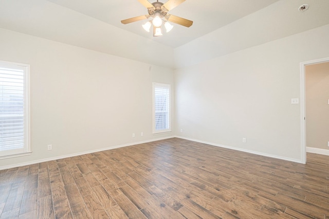 spare room featuring dark wood-type flooring and ceiling fan