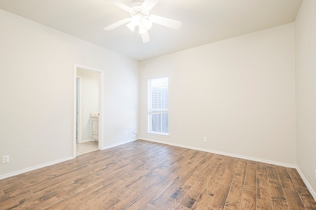 empty room featuring wood-type flooring and ceiling fan