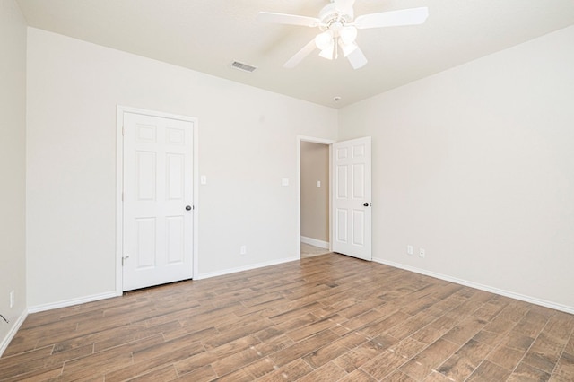 unfurnished room with ceiling fan and hardwood / wood-style floors