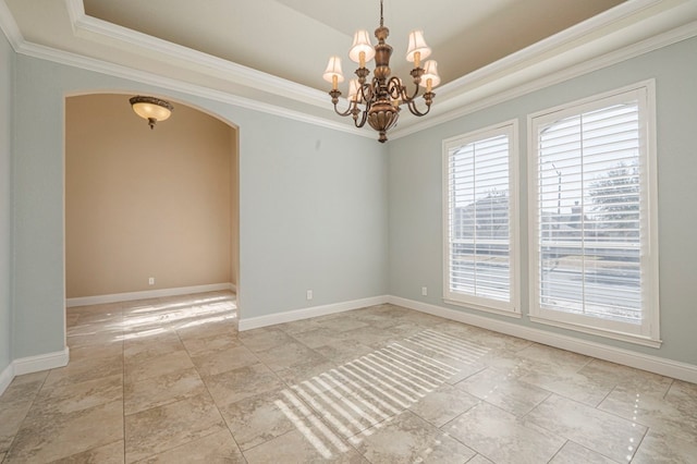 unfurnished room with a notable chandelier, crown molding, and a raised ceiling