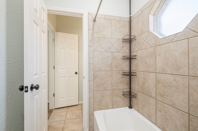 bathroom featuring tile patterned flooring and tiled shower / bath combo