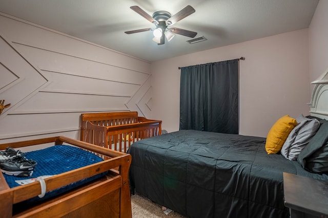 bedroom with visible vents, carpet flooring, and ceiling fan