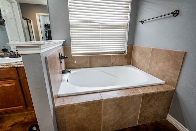 bathroom featuring vanity, a bath, and a stall shower