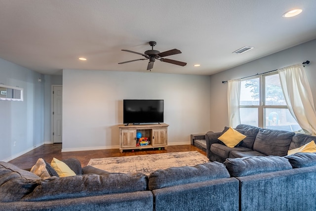 living room featuring a ceiling fan, baseboards, recessed lighting, and visible vents