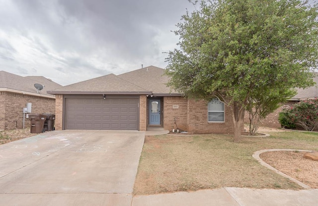 ranch-style home with roof with shingles, a front lawn, brick siding, a garage, and driveway