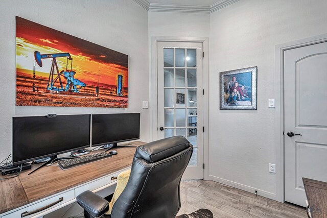 office area with light wood-style floors, ornamental molding, and baseboards