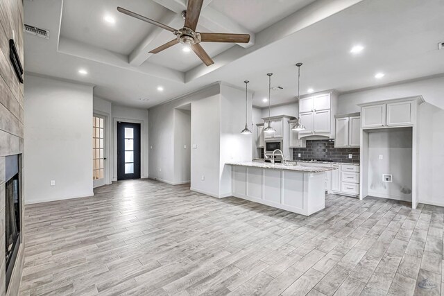 office area featuring baseboards, wood finished floors, a ceiling fan, and crown molding