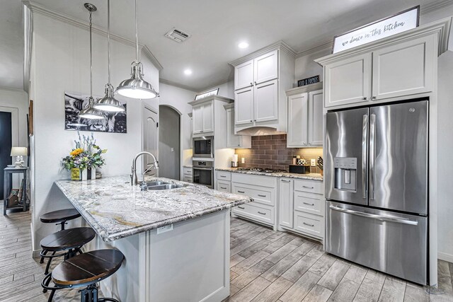 dining space with recessed lighting, a large fireplace, visible vents, wood finish floors, and crown molding