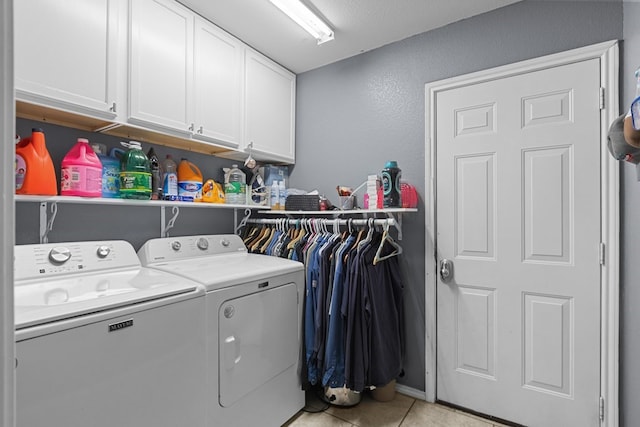 1004 Jefferson St, Odessa, TX 79761 - laundry room with washer and clothes dryer, cabinet space, and light tile patterned floors