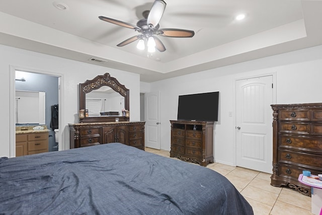 1004 Jefferson St, Odessa, TX 79761 - bedroom with light tile patterned flooring, a tray ceiling, a ceiling fan, recessed lighting, and ensuite bath