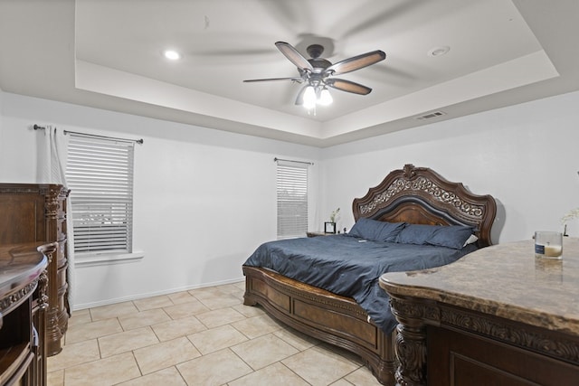 1004 Jefferson St, Odessa, TX 79761 - bedroom with a tray ceiling, light tile patterned floors, baseboards, and a ceiling fan