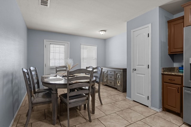 1004 Jefferson St, Odessa, TX 79761 - dining area featuring baseboards and light tile patterned floors