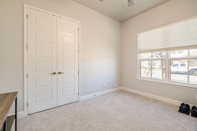 spare room with plenty of natural light, a ceiling fan, and carpet flooring