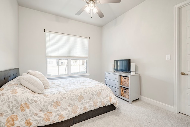 bedroom with ceiling fan, baseboards, and light carpet