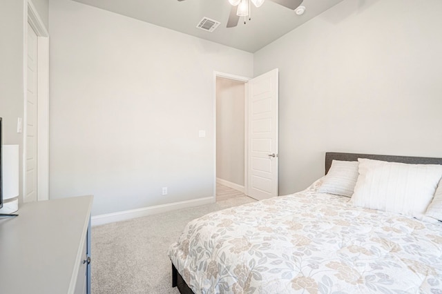 carpeted bedroom with visible vents, a ceiling fan, and baseboards