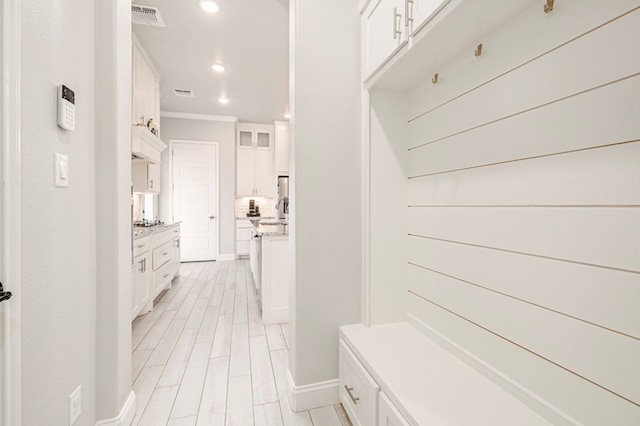 mudroom featuring crown molding, recessed lighting, visible vents, and baseboards