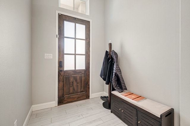 mudroom with baseboards and light wood-style floors