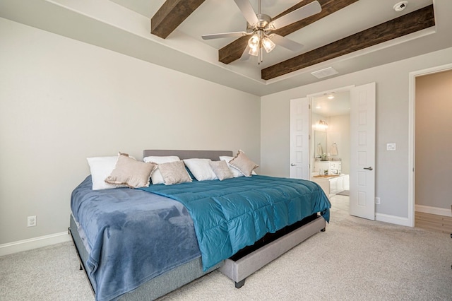 bedroom with beamed ceiling, light colored carpet, and baseboards