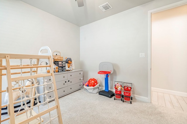carpeted bedroom featuring baseboards, visible vents, and ceiling fan