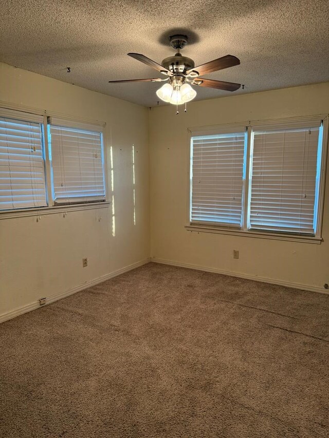 2203 40th St, Snyder, TX 79549 - carpeted spare room with a textured ceiling, ceiling fan, and baseboards