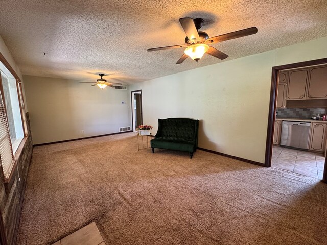 2203 40th St, Snyder, TX 79549 - sitting room with ceiling fan, light carpet, a textured ceiling, and baseboards