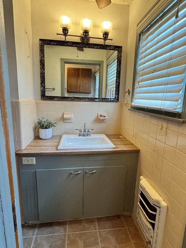 2203 40th St, Snyder, TX 79549 - bathroom featuring vanity, tile walls, and tile patterned floors