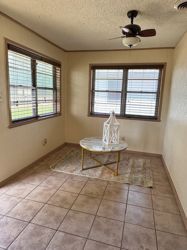2203 40th St, Snyder, TX 79549 - dining room with a textured ceiling, light tile patterned floors, ceiling fan, and ornamental molding