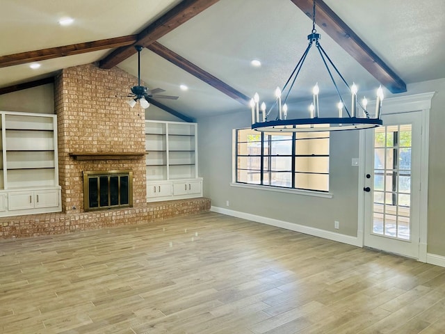 unfurnished living room featuring a brick fireplace, ceiling fan with notable chandelier, a textured ceiling, light hardwood / wood-style flooring, and vaulted ceiling with beams