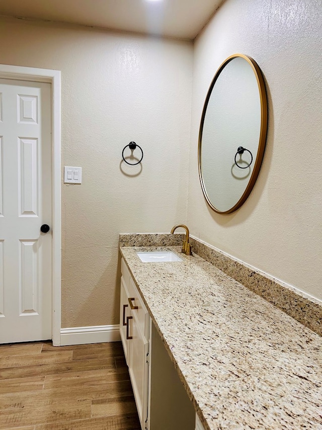 bathroom featuring hardwood / wood-style floors and vanity