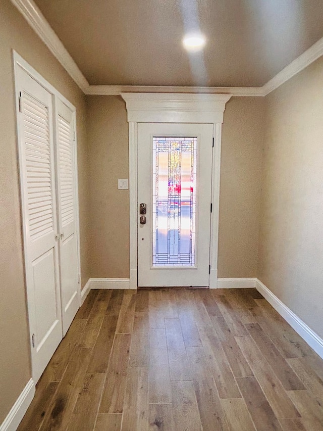 entryway with crown molding and hardwood / wood-style flooring