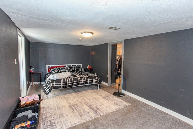 2101 Grace St, Big Spring, TX 79720 - bedroom featuring a textured ceiling and carpet flooring