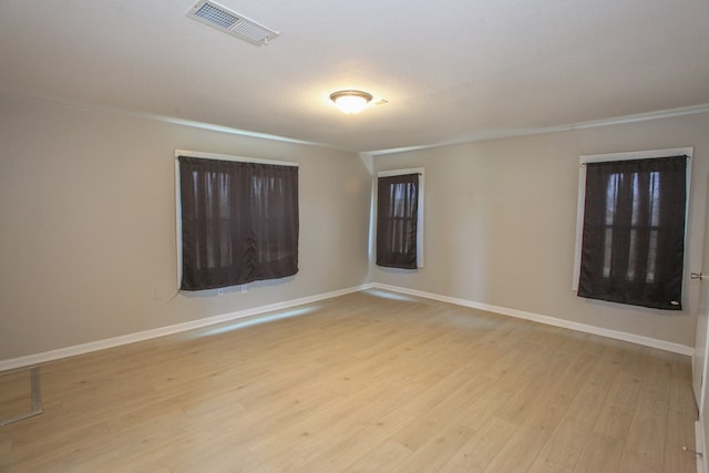 2101 Grace St, Big Spring, TX 79720 - empty room featuring light wood-type flooring and crown molding