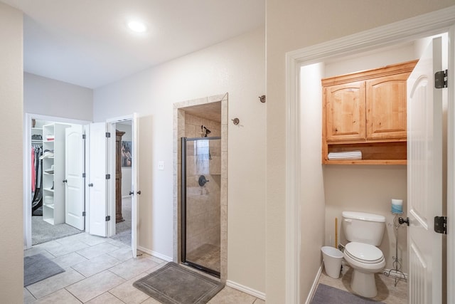 3124 Patrick Pl, Midland, TX 79705 - full bath featuring a spacious closet, a shower stall, toilet, baseboards, and tile patterned floors