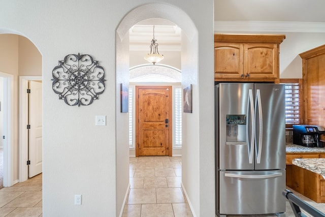 3124 Patrick Pl, Midland, TX 79705 - kitchen with stainless steel fridge with ice dispenser, arched walkways, healthy amount of natural light, and crown molding