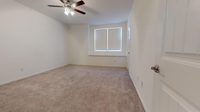 unfurnished room with a ceiling fan, light colored carpet, and baseboards