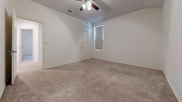 carpeted spare room with visible vents, ceiling fan, baseboards, and lofted ceiling