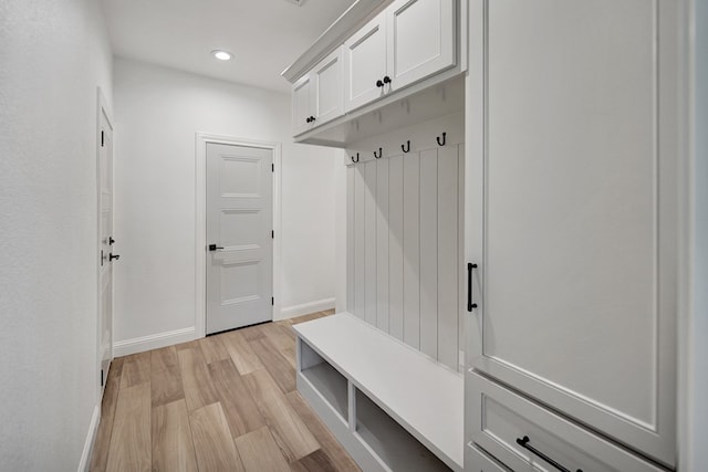 mudroom featuring recessed lighting, light wood-style flooring, and baseboards