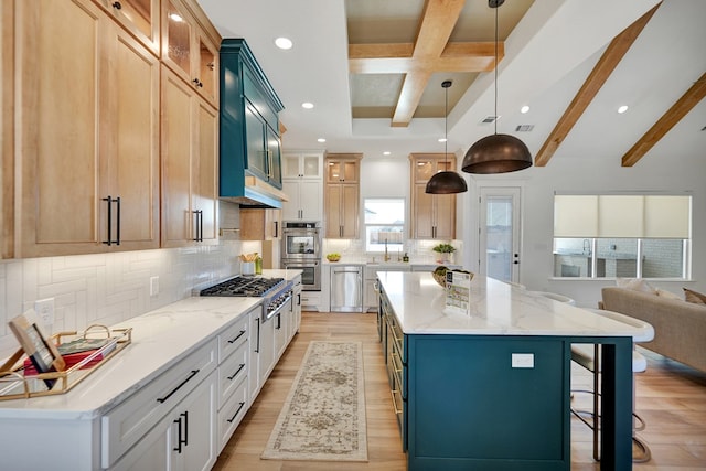 kitchen featuring glass insert cabinets, a kitchen island, white cabinets, appliances with stainless steel finishes, and decorative light fixtures