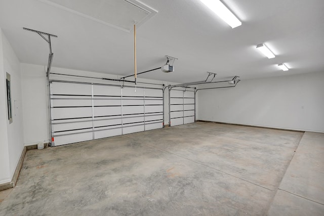 garage with a garage door opener and baseboards