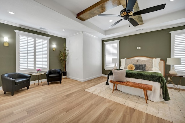 bedroom with light wood finished floors, baseboards, visible vents, and crown molding