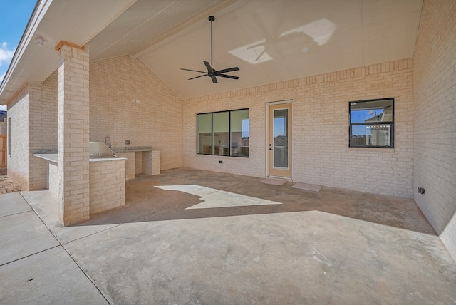 view of patio / terrace with ceiling fan and an outdoor kitchen