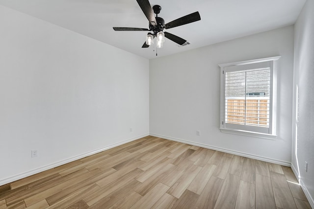 unfurnished room featuring light wood-type flooring, ceiling fan, and baseboards