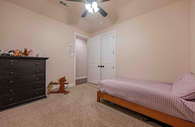 carpeted bedroom featuring visible vents, a ceiling fan, and baseboards